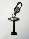 SAUMI Buddy - transport holder for SAUMI with a carbon fiber design and 'SAUMI' branding on a white background